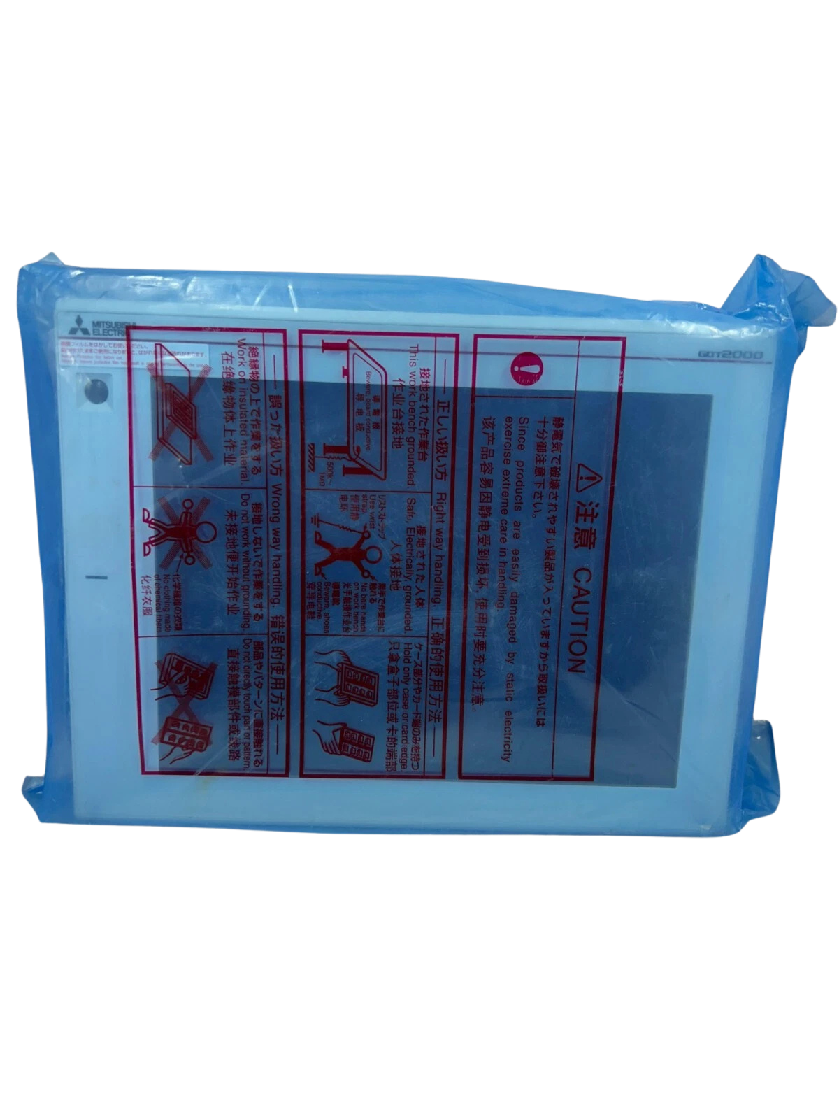 MITSUBISHI ELECTRIC GT2712-STWD(2)c Mitsubishi Electric GT2712-STWD GOT2000 human machine interface panel sealed inside original blue anti-static protective plastic packaging showing static handling caution warnings.