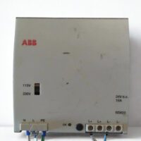 Front panel of ABB SD823 power supply unit featuring the 115V/230V voltage selector switch, 24V DC 10A output indicator, and wiring terminal connections for N, L, PE, and L+/L-