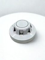 45-degree perspective view of the Apollo Series 65 Optical Smoke Detector highlighting the raised smoke entry vents and "Do Not Paint" warning embossed on the casing.