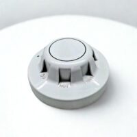 45-degree perspective view of the Apollo Series 65 Optical Smoke Detector highlighting the raised smoke entry vents and "Do Not Paint" warning embossed on the casing.