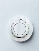 Top-down view of Apollo Series 65 Optical Smoke Detector 55000-316APO featuring a sleek white circular design with a central sensor chamber and indicator LED
