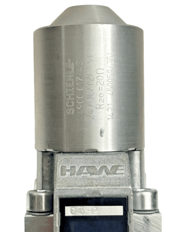 Schienle-Solenoid-Technical-Details-24V-DC Detailed engraving on a HAWE valve solenoid showing Schienle 24V DC specs, 1.2A current, and R20 20 Ohm resistance