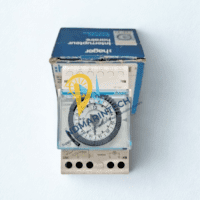 New Hager EH110 daily time switch sitting in front of its original blue Hager packaging.