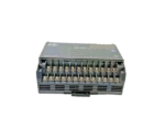 Close-up of the dual-tier screw terminal blocks on a Keyence KV-40R PLC for wiring inputs and relay outputs.