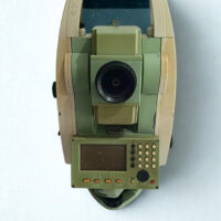 Front view of a Leica FlexLine TS06-1 total station featuring the alphanumeric keypad, high-resolution display screen, and optical lens.