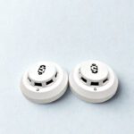 Two Sekurit SK-804 photoelectric smoke detectors in white finish