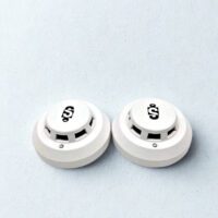 Two Sekurit SK-804 photoelectric smoke detectors in white finish