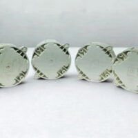 Rear view of four Tyco DHM-5B (517.050.603) deckhead mounting bases showing the ruggedized exterior casing and integrated mounting tabs for fire detector installation