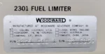 Detailed close-up of Woodward Governor Company nameplate for Fuel Limiter P/N 8271-518 and Serial Number 2305855