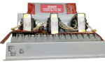 Close-up of Tranex transformers on a Woodward 8271-250 C Load Sensor with high voltage warning labels