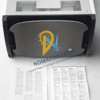 Front view of the Aeroflex TM500 test unit featuring a grey protective faceplate with a power button, accompanied by printed instruction manuals laid out in front