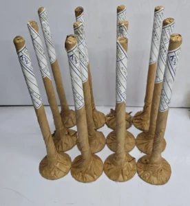Wrapped Daihatsu DL-20 Intake Valves Multiple engine intake valves individually wrapped in brown protective paper with KSV labeling, standing vertically on a white surface.