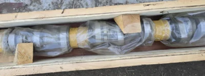 Daihatsu Engine Camshaft Packaged Horizontal view of a heavy-duty steel camshaft wrapped in plastic wrap and padded with wooden blocks inside a long wooden shipping box.
