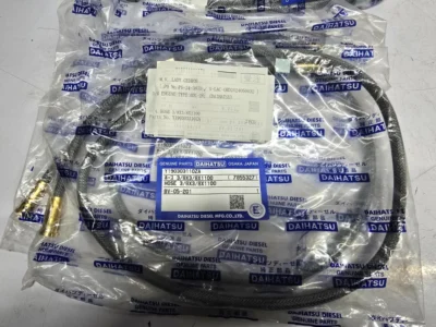 Daihatsu Flexible Braided Hose (Y190303110ZA) A coiled, braided steel flexible hose wrapped in a branded Daihatsu Diesel genuine parts plastic bag with label part number Y190303110ZA.