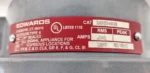 Close-up of the red technical label for Edwards Signaling 340EX-8N5 showing 120V 50/60Hz ratings and UL hazardous location certifications