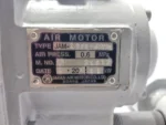 Close-up of the official JAM Air Motor nameplate for model 1.5PE-450DR showing 0.6 MPa operating pressure and 1.1 kW power rating.