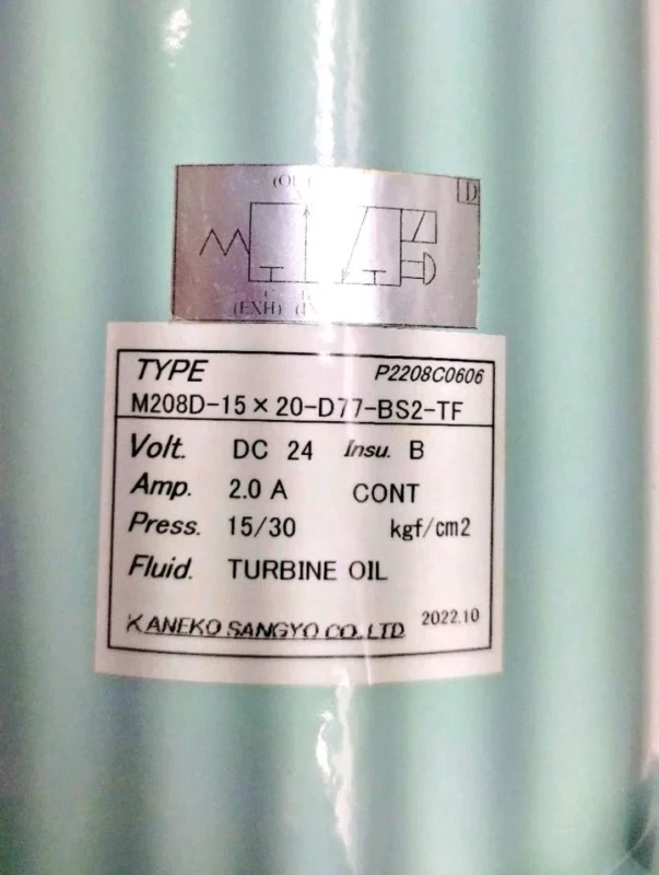 Kaneko Sangyo M208D Solenoid Valve Technical Label Technical nameplate of Kaneko Sangyo M208D-15×20-D77-BS2-TF solenoid valve showing DC 24V, 2.0A, and 15/30 kgf/cm2 pressure rating.