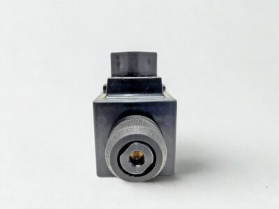 Solenoid End View of Parker D1VW004CNYW91 Hydraulic Valve. Side view of Parker D1VW004CNYW91 valve solenoid showing manual override pin and rugged industrial casing.