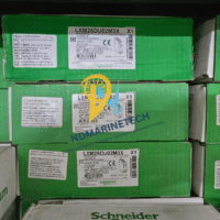 Bulk stock of Schneider Electric LXM26DU02M3X Lexium 26 servo drives in original green packaging with visible labels.