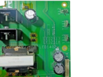 Detailed view of the Schneider VX4PPC16N4 power drive board showing capacitors, color-coded wiring terminals (violet, green, yellow), and LED indicators.