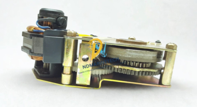 Internal mechanical gear reduction system of ABB 1SDA038324R1 motor device. Side profile of ABB 1SDA038324R1 geared motor operator displaying heavy-duty internal spur gears, reduction mechanism, and motor armature stack.