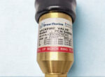 Close-up of Drew Marine PCN 548026 backfire valve label showing ISO 5175-1 compliance and pressure ratings.