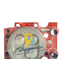 Brand new cylinder head assembly for MAN B&W L40/54 marine diesel engine showing valve faces, flame plate, and red painted housing.