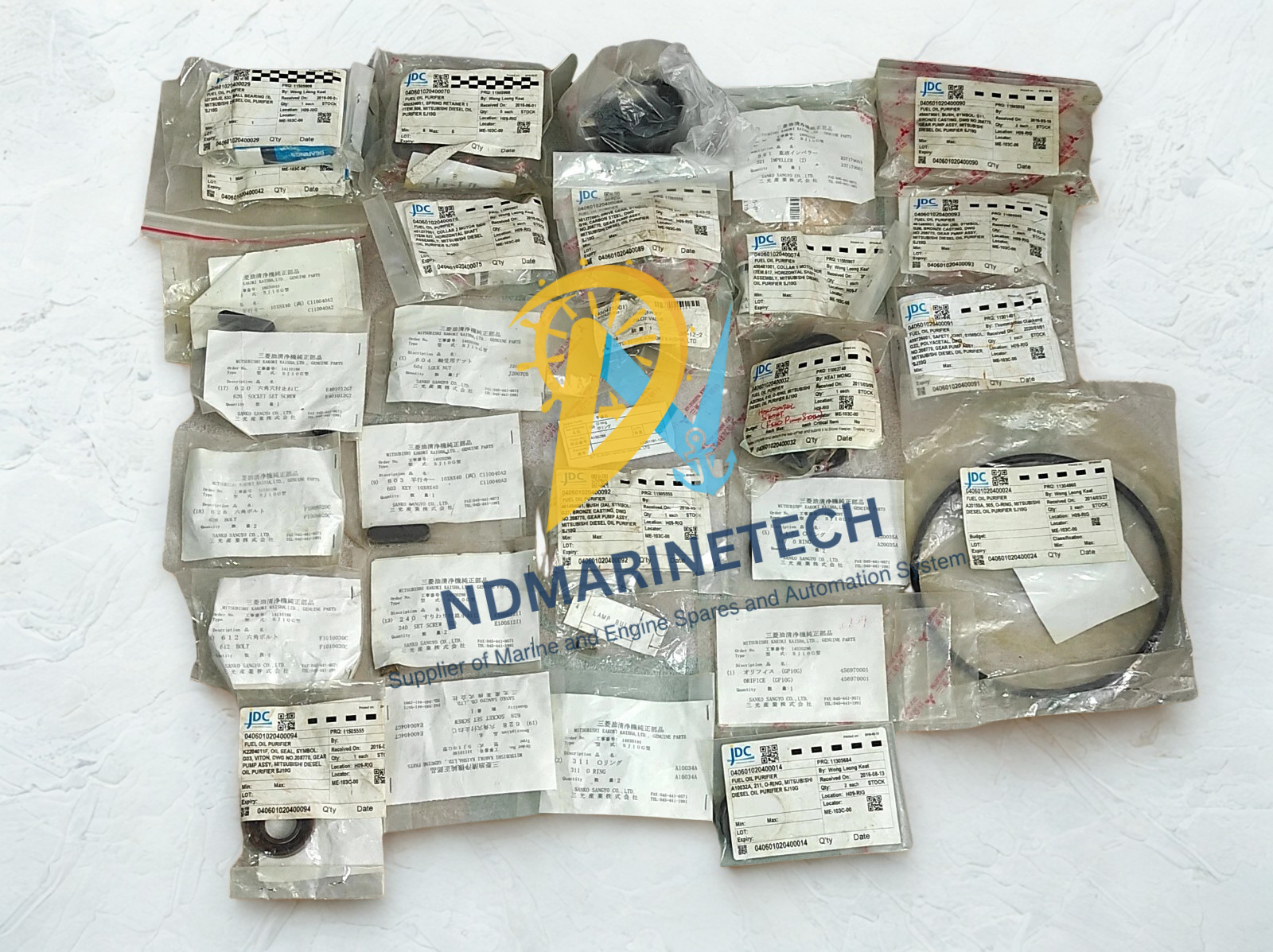 Mitsubishi Diesel Oil Purifier SJ10G Spares Comprehensive inventory of genuine Mitsubishi Diesel Oil Purifier SJ10G spares, including OEM-packaged bowl seals, NTN bearings, gear pump bushes, and horizontal shaft accessories arranged as a complete maintenance overhaul lot.