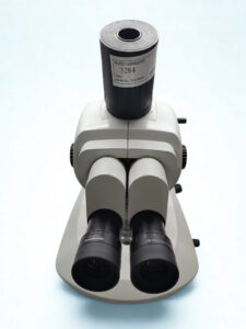 Olympus SZX10 Eyepieces and Watec Camera Integration Top-down perspective of Olympus microscope eyepieces and trinocular port featuring a Watec camera (IVF) model WAT-209H2.