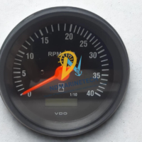 Front dial closeup of a VDO 0 to 40 RPMx100 marine tachometer gauge featuring an integrated digital hour meter window.