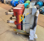 Side view of the withdrawable ABB HD4.W 12.12.32 circuit breaker highlighting the auxiliary wiring conduit and racking chassis wheels.