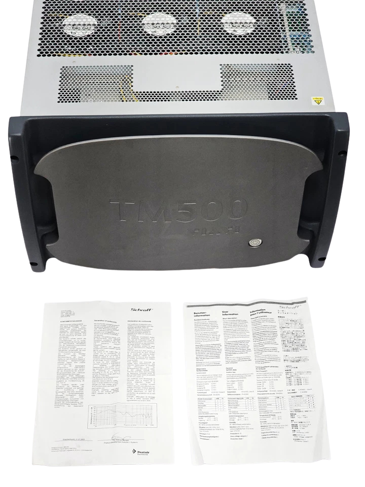Aeroflex TM500 New Front view of the Aeroflex TM500 test unit featuring a grey protective faceplate with a power button, accompanied by printed instruction manuals laid out in front