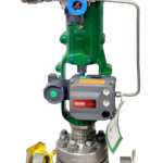 Complete assembly of a green Fisher 667 HPS globe control valve with an Emerson DVC6200 FIELDVUE positioner and a flanged stainless steel body.