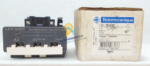 Telemecanique LX1FG380 replacement coil for TeSys F contactor standing next to its original Schneider Electric factory packaging box with barcode label.