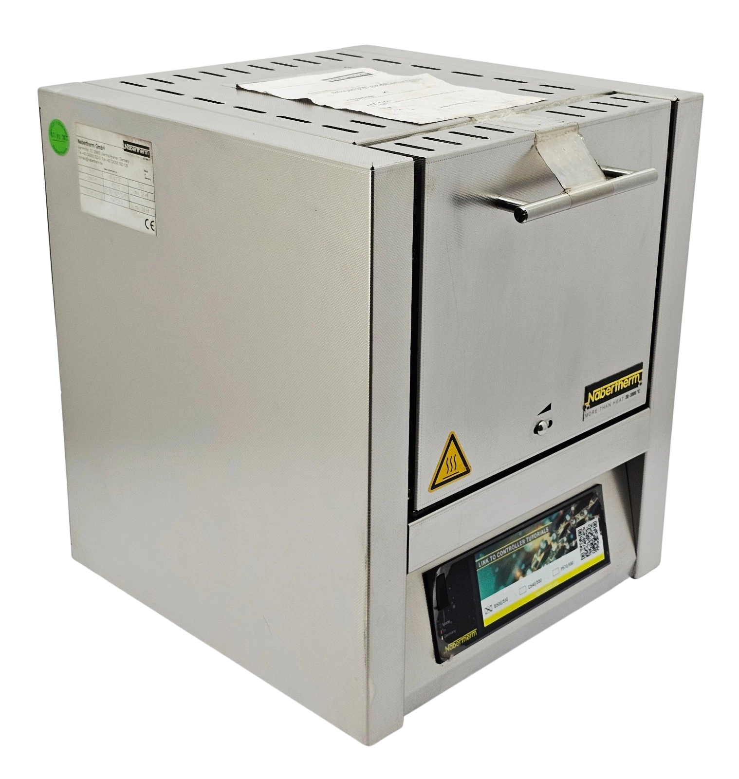 Nabertherm L 5 11 Muffle Furnace New Front view of a stainless steel Nabertherm L 5/11 laboratory muffle furnace with digital program controller interface and original operator manual on a white countertop.