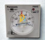 Close-up front view of Panasonic PM4S-A2C10M-AC120V multi-range timer showing the analog dial setting, time ranges, and mode selector switch.