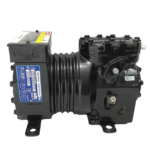 Full side profile view of the black Copeland KAM1-010A-TAD-800 semi-hermetic reciprocating compressor showing mounting feet base, central heat dissipation ribs, and blue spec plate location.