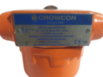 Technical specification nameplate on Crowcon Flamgard Plus orange flameproof enclosure detailing Sira 03ATEX1124X certification, Vmax 30V, and II 2G Ex d rating.