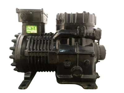New 10 HP DWM Copeland Reciprocating Compressor D9RC4-1000-AWM/D New DWM Copeland D9RC4-1000-AWM/D 10 HP industrial reciprocating compressor side profile highlighting cooling fins and cylinder head assembly