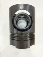 Front view of a brand new Daihatsu 6DL-20 marine engine piston showing the precision-machined gudgeon pin bore and lower skirt structure.