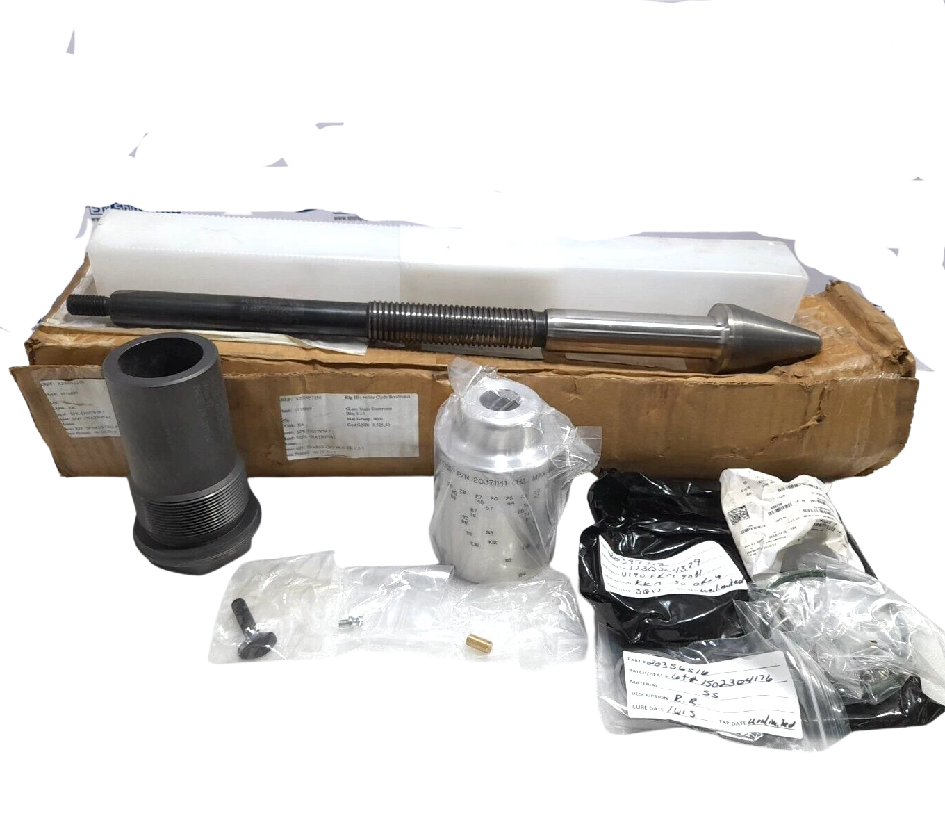 NOV SPK-51037879-3 Spares Kit Complete National Oilwell Varco SPK-51037879-3 spares kit featuring a precision-machined adjustable stem with tungsten carbide tip, matching valve seat sleeve, aluminum position indicator scale, and associated API 6A seal kits displayed with the factory shipping box.