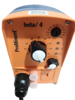 Close-up of ProMinent Beta 4 dosing pump control panel, showing stroke length knob, frequency dial, and indicator lights on orange casing.