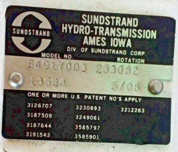 Sundstrand 64917003 233082 Serial Plate Details Sundstrand Hydro-Transmission model plate showing Model No 64917003 and code 233082 with serial number 13584