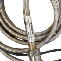 UNISON Industries 9059355-204 explosion proof ignition lead label showing GE P/N and FM certification stamp on stainless steel braided cable.