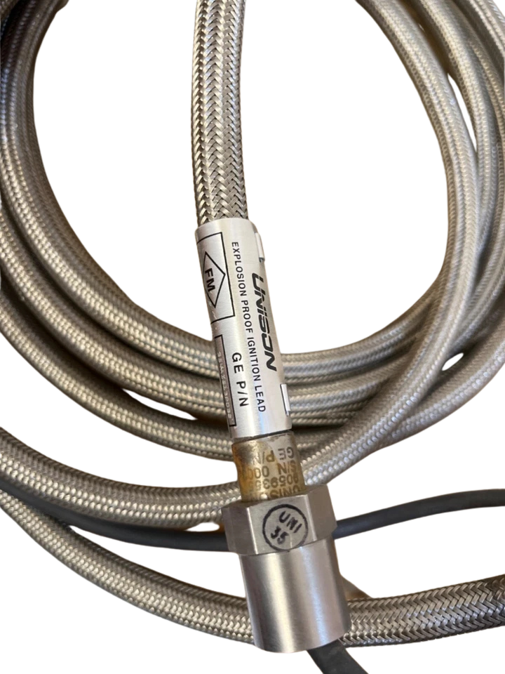 UNISON Ignition Head 9059355-204(1) UNISON Industries 9059355-204 explosion proof ignition lead label showing GE P/N and FM certification stamp on stainless steel braided cable.