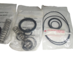 Set of three sealed Williams Milton Roy P1000V pump repair kits with o-rings, springs, and lubricant.