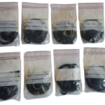 Multiple sealed packets of OEM Damcos A/S 219-0200 seal sets for marine valve actuators.