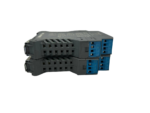 Top-down angle of two GM International D1072D temperature converters highlighting blue plug-in safe-area terminals.