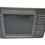 Close-up of Mitsubishi Electric E1100 MPN 06045C label detailing 24VDC 1.0A power rating, CE mark, and serial number