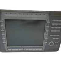 Close-up of Mitsubishi Electric E1100 MPN 06045C label detailing 24VDC 1.0A power rating, CE mark, and serial number